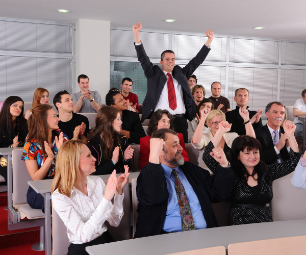 Team exhilarated and celebrating at seminar