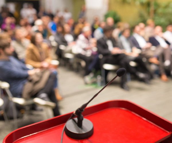audience seated and microphone at round table